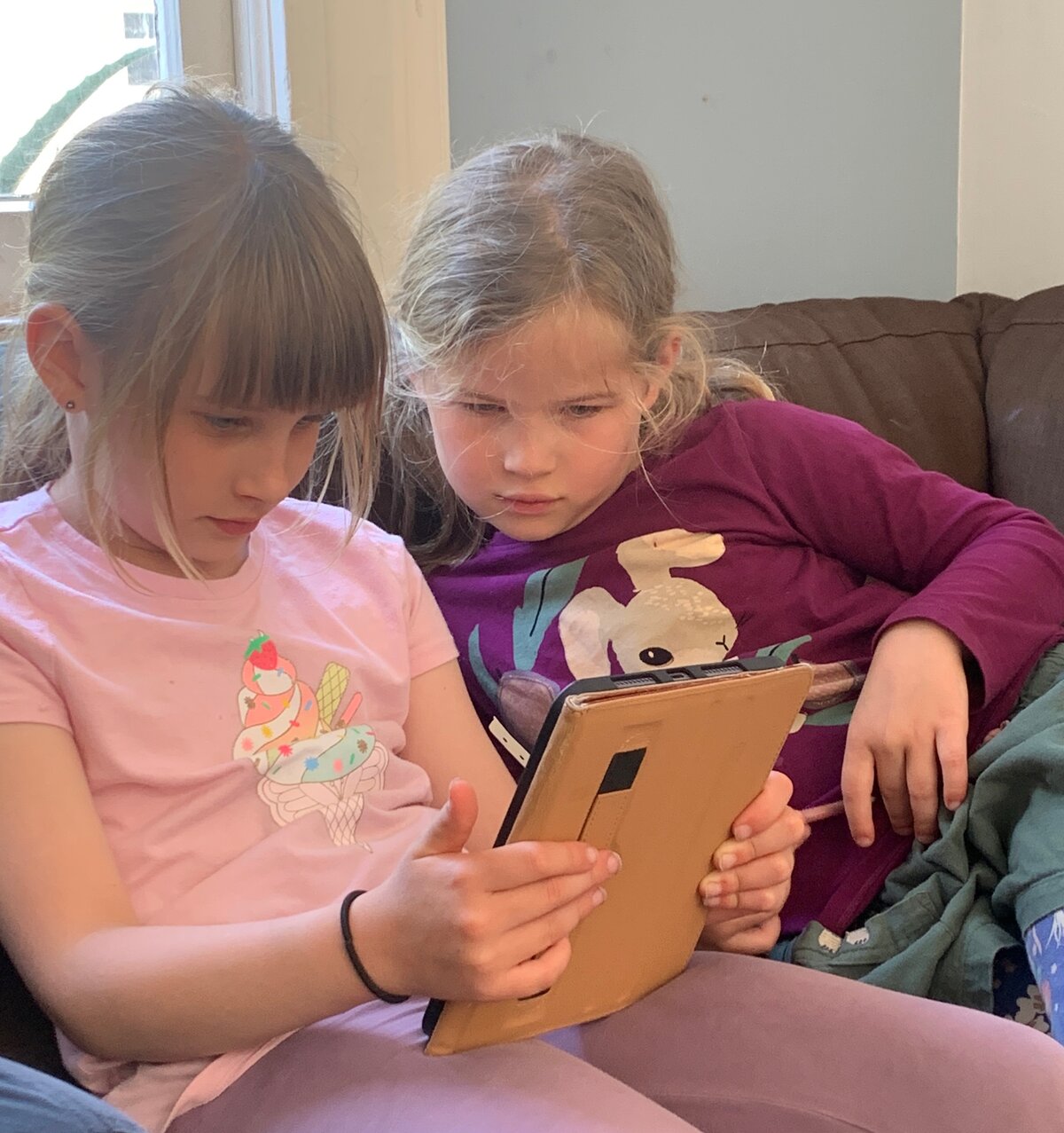 Two kids playing Wyla together on a tablet